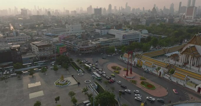 An aerial view of Red Giant Swing and Suthat Thepwararam Temple at sunset scene, The most famous tourist attraction in Bangkok, Thailand.