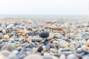 Close-up of pebble beach with blurred horizon at the greek island of Crete