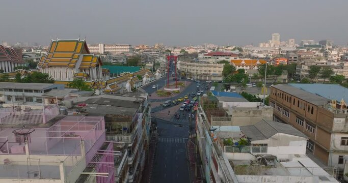 An aerial view of Red Giant Swing and Suthat Thepwararam Temple at sunset scene, The most famous tourist attraction in Bangkok, Thailand.