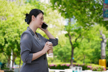 Businesswoman Multitasking with Coffee and Phone Call