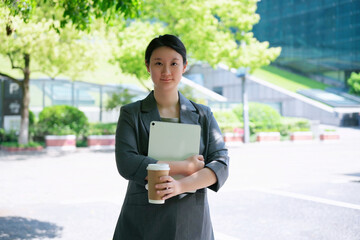 Professional Businesswoman with Tablet and Coffee Outdoors
