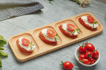 Bruschetta sandwiches with cottage cheese and tomato for lunch. A healthy snack for people on a special diet