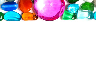 Colorful gem stones on white background with copy space for message. Background for design purpose.