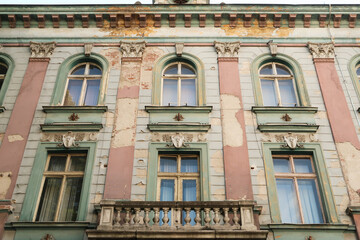 A balcony and windows on the beautiful upper facade of the former Bulgarian National Bank building in the old town of Plovdiv, Plowdiw, Bulgaria