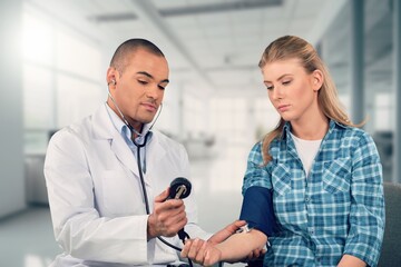 Happy young woman talking with doctor in hospital