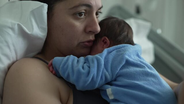 New mother in hospital bed holding newborn baby on chest, showcasing bonding and emotional connection, healthcare setting, postnatal care, nurturing love, and modern motherhood