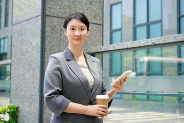 Confident Businesswoman with Smartphone on a Coffee Break