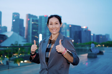 Confident Businesswoman Giving Thumbs Up in the City