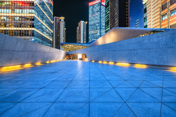 Empty square floors with modern city buildings at night in Shanghai