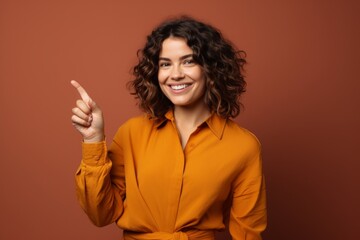 Portrait of a glad woman in her 30s showing a thumb up isolated in solid color backdrop