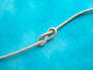 Rope knot on blue background