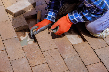 Reconstruction destroyed brick path refers to replacement broken portion of pavement.