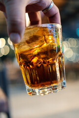 Cropped hand of man holding alcoholic drink