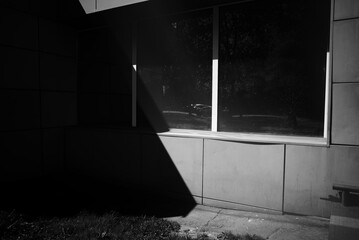 Black and white diagonal light ray on street backdrop building