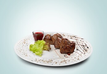 Barbecue grilled beef meat on a plate.