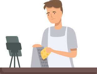 Young man prepares food by grating cheese, standing in a home kitchen with a focused look