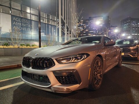 New York City, USA - March 05, 2024: 2023 BMW M8 Competition convertible luxury grey car parked outside, angle view