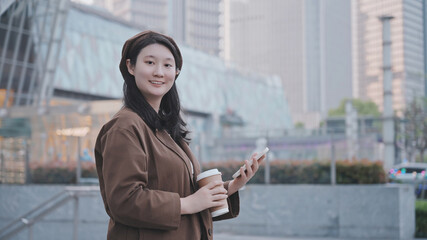 Confident Businesswoman with Smartphone in Urban Setting