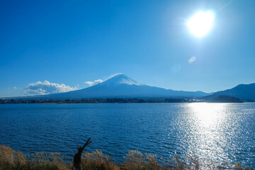 A distant view on Mt Fuji in Japan on a clear,The top parts of the volcano are covered with a layer of snow.