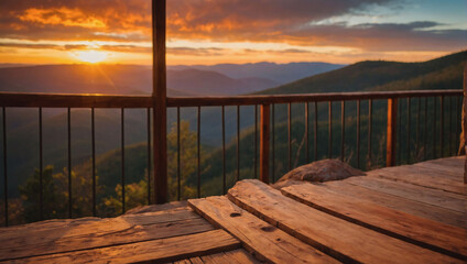 Wooden porch on a mountain cliff at sunset, bathed in warm orange light