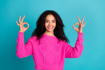 Photo of lovely young girl show okay symbol wear pink pullover isolated on teal color background