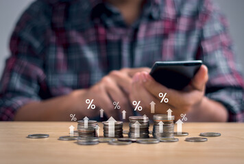 Interest rate and Inflation, Debt rate, Financial percentage concept. Stack of coins on table and financial percentage with businessman showing calculation of central bank interest rate increase