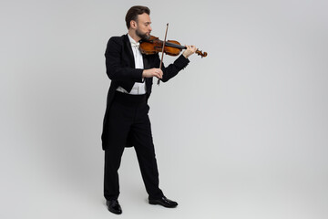 Bearded man passionate violin player at classical music performance