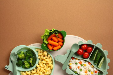 Top view of a colorful, nutritious meal in green animal-shaped dishes. Ideal for content on healthy...