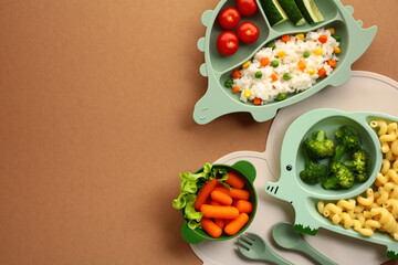 Naklejka premium Kid-Friendly Healthy Meals. Nutritious meals served on animal-shaped plates. Features a dinosaur plate with tomatoes, cucumbers, and rice, a elephant plate with broccoli and pasta, and bowl of carrots
