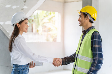 construction worker and contractor. Client shaking hands with team builder in renovation site.
