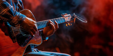 Close-up of a musician's hands playing an acoustic guitar, illuminated by stage lights