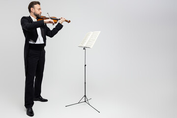 Professional violinist with notes playing classical music