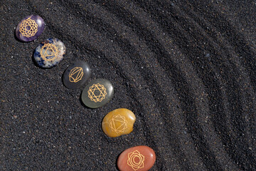 Healing crystals on black sand background