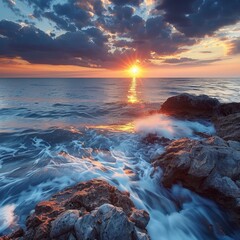 Fototapeta premium The ocean is calm and the sun is setting, creating a beautiful