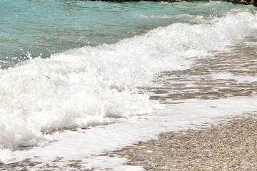 the waves of the sea run to the sandy shore