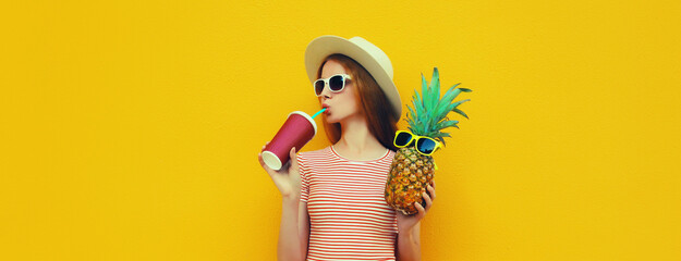 Summer portrait of stylish young woman drinking fresh juice with pineapple fruit