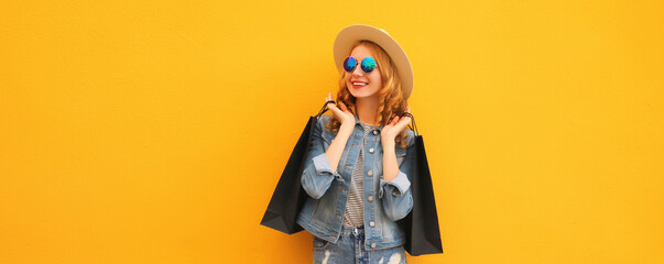 Shopping day! Stylish beautiful happy smiling young woman with black shopping bags, wear summer hat