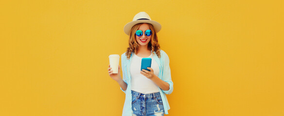 Summer portrait of happy young woman with mobile phone holding cup of coffee ion yellow background