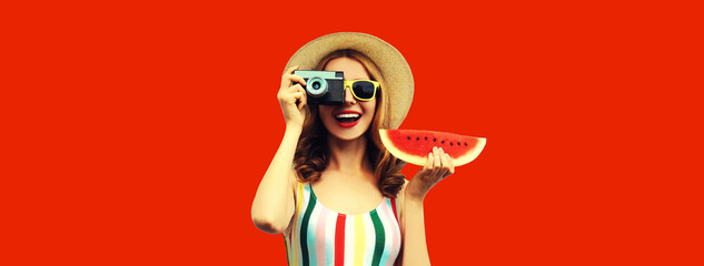 Summer portrait happy smiling young woman with film camera and slice of fresh watermelon wearing hat