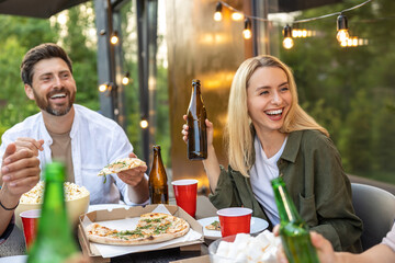 Cheerful friends having picnic outdoor drinking beer enjoying weekend