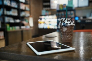 a digital tablet on a table in a coffee shop