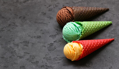 assorted ice cream of different flavors in waffle cones