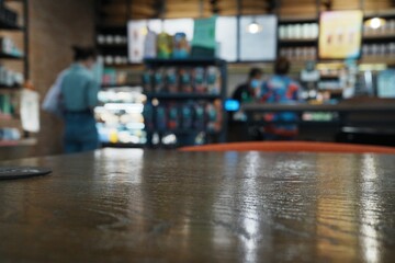 Blurred coffee shop interior with wooden table in foreground