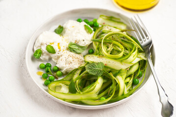 Salad with fresh asparagus, green peas, aromatic herbs with Bufala mozzarella. Healthy summer and...