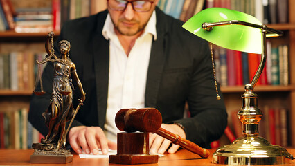 Justice and law concept. Lawyer works with laptop in court office. Concept of legal work, litigation.