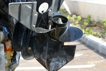 The propeller of a motor boat at the pier in the seaport.