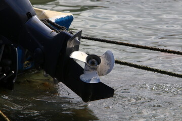 The propeller of a motor boat at the pier in the seaport.