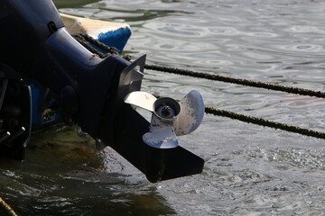 The propeller of a motor boat at the pier in the seaport.