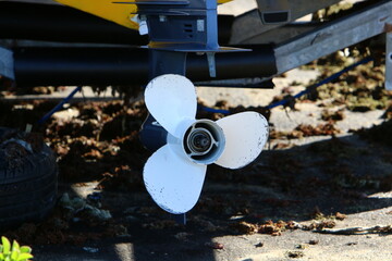 The propeller of a motor boat at the pier in the seaport.