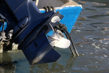 The propeller of a motor boat at the pier in the seaport.